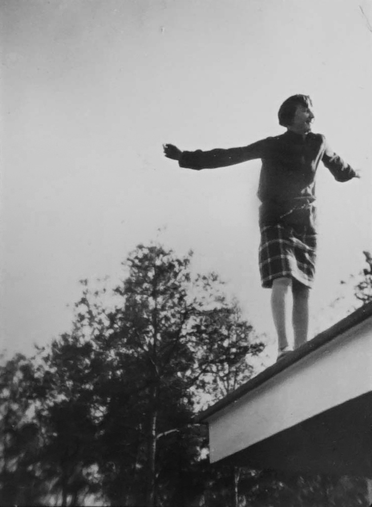 Girl balancing at edge of roof of the Meisterhaus