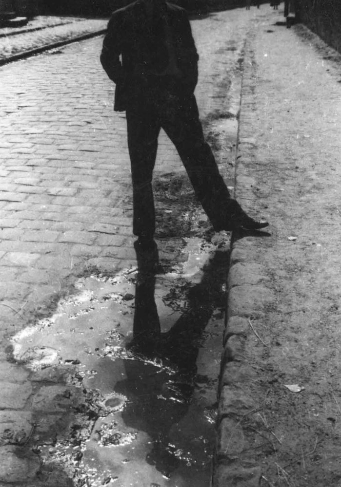 Man mirrored in a Puddle