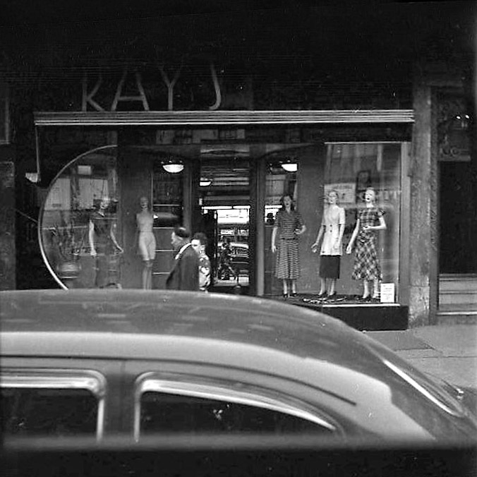 Couple mirrored in Kay's Shop Window