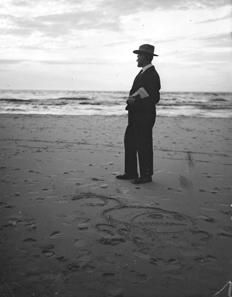 Lyonel Feininger standing on the Beach in Deep
