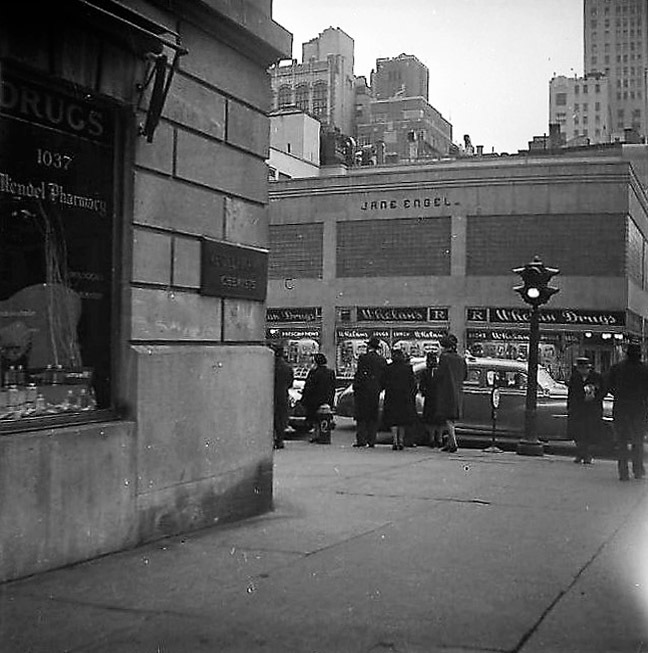 Pedestrians in front of Whelan Drugs at 8th Ave. and 44th St. I