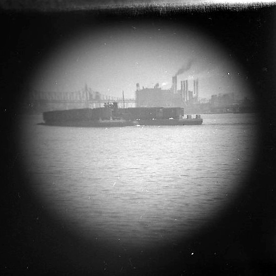 View of the Queensboro Bridge, Train-barge on the East River [Telescope view]