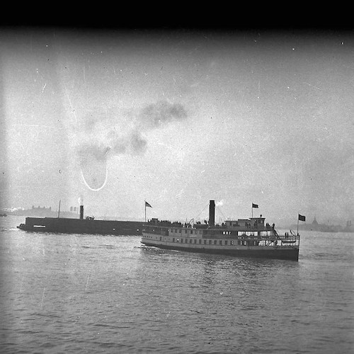 Excursion Steamer and Towing Unit with Tug , Ellis Island and Ctl. R.R. of New Jersey Terminal in the background
