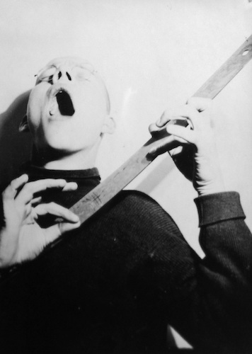 Georg Hartmann mimes a singer with guitar