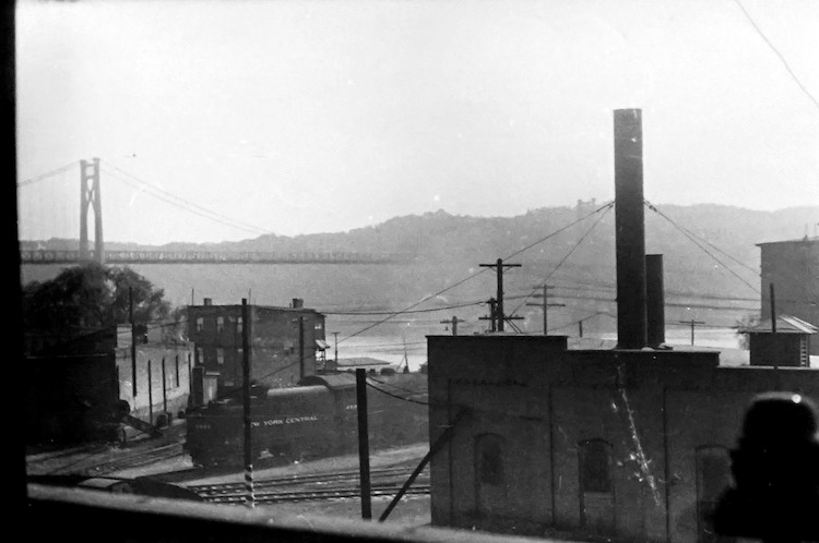View of New York Central Train over Railroad Tracks, Bridge in background