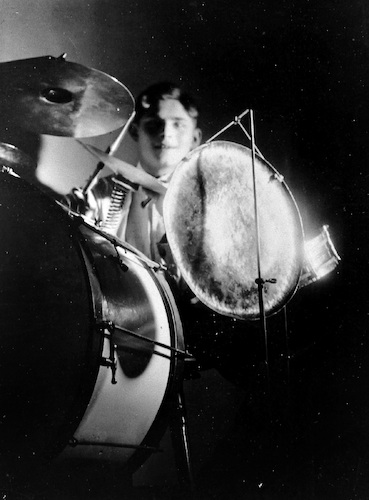 Roman Clemens playing drums, hitting cymbal