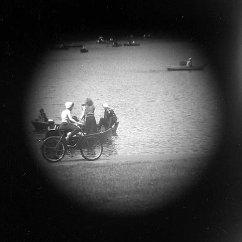 Central Park Lake. Group and Girl on Bike [Telescope view]