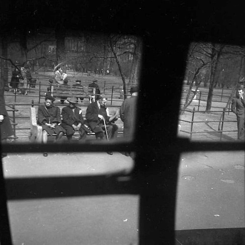 People on a Bench at Madison Square, photographed from inside a Bus