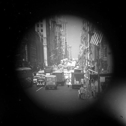 Fifth Avenue. From upper deck of bus, American Flag [Telescope view]