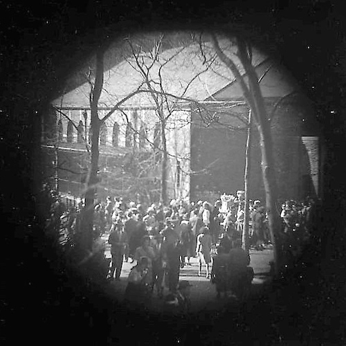 Crowd in a Park, Building in background [Telescope view]